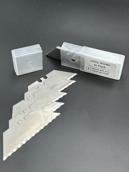 Set of utility blades with packaging on a gray background
