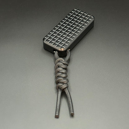 Black leather lanyard tied to Rivery Zero Knife, with blade retracted