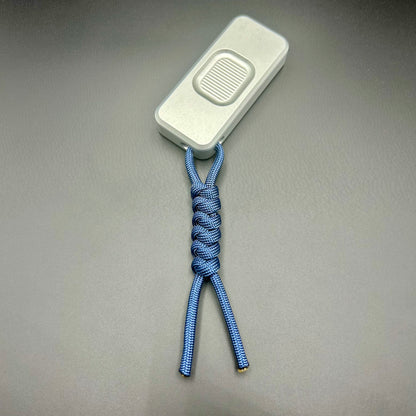 Blue paracord lanyard tied to Rivery Zero Knife, with blade retracted