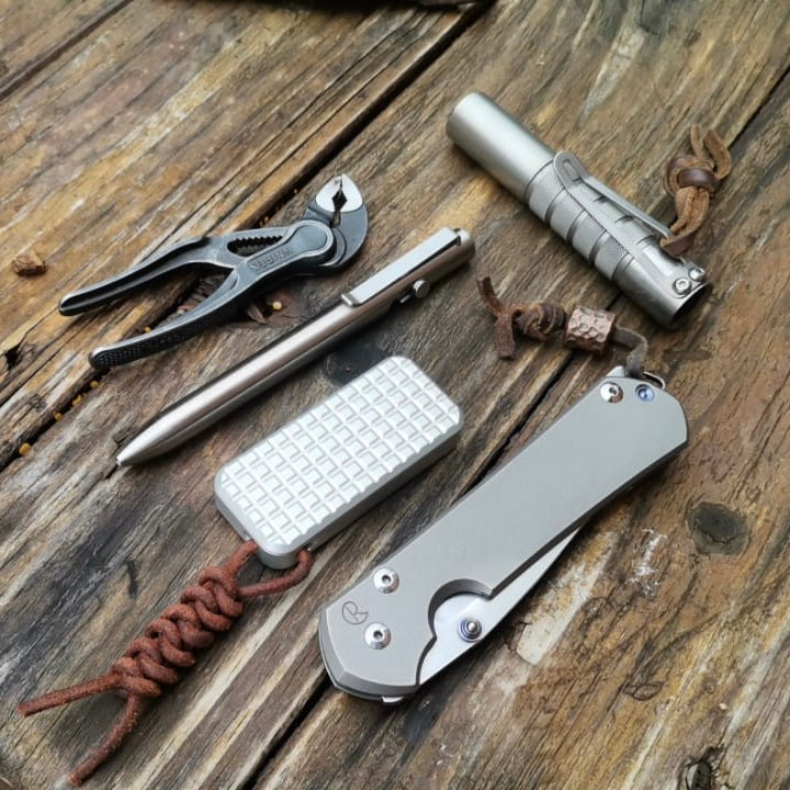 Set of multi-tool knives and tools on a wooden surface