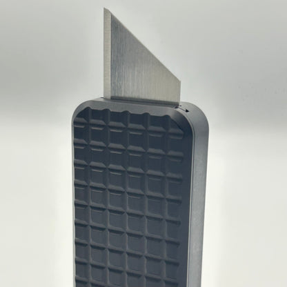 Grenade Black Zero knife standing vertically with blade exposed