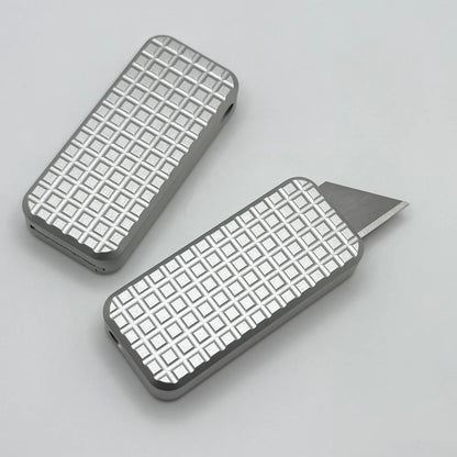 Two Zero knives next to each other, one with blade showing and the other with blade retracted, displayed on a white background