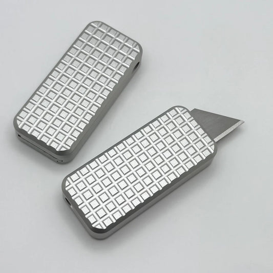 Two Zero knives next to each other, one with blade showing and the other with blade retracted, displayed on a white background