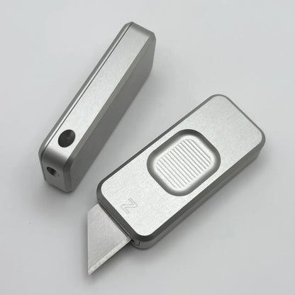 Two Zero knives next to each other, one with blade showing and the other with blade retracted, displayed on a white background