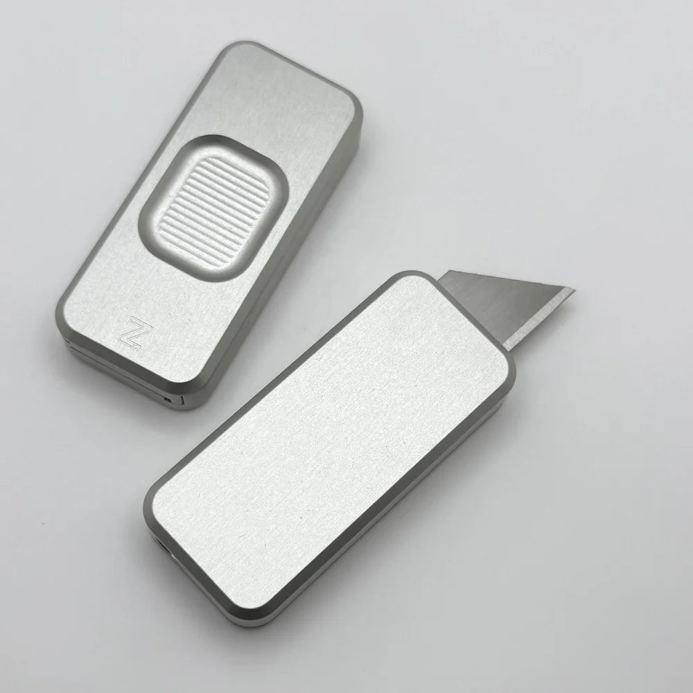 Two Zero knives next to each other, one with blade showing and the other with blade retracted, displayed on a white background