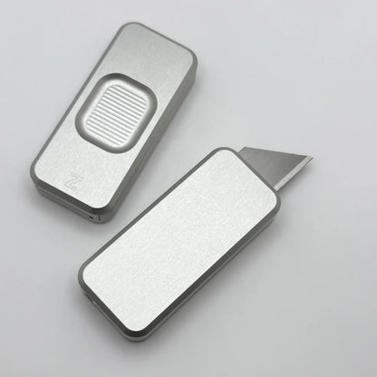 Two Zero knives next to each other, one with blade showing and the other with blade retracted, displayed on a white background